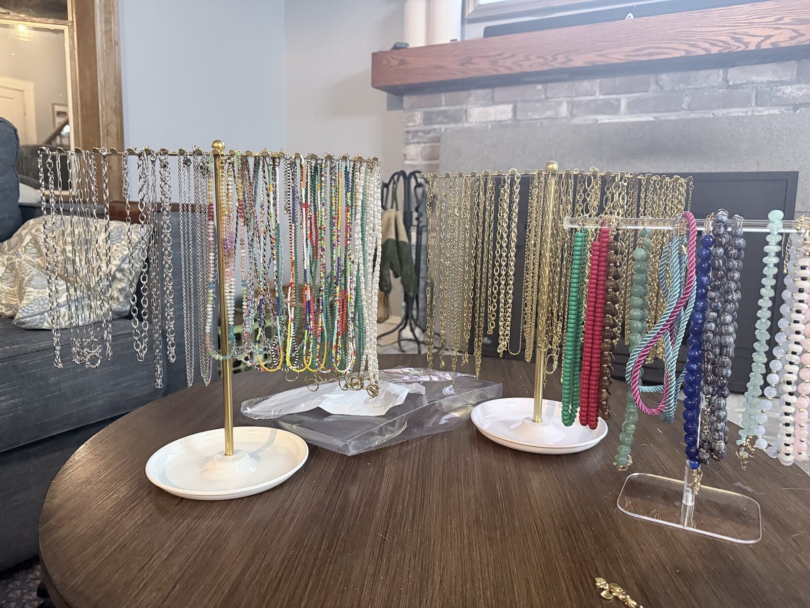 A beading party necklace bar with chains and strung beads on display stands