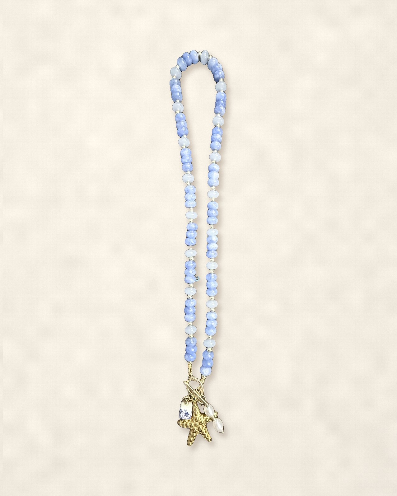 Periwinkle beaded necklace with a gold starfish and pearl charms