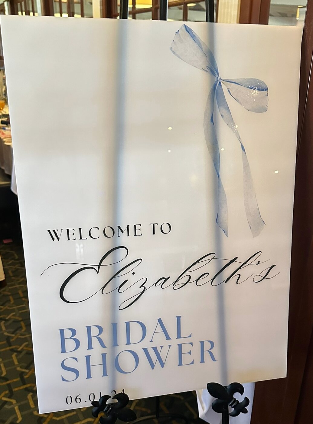 Bridal shower welcome sign with a watercolor blue bow