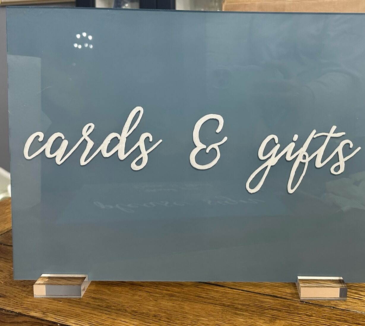 Dusty blue acrylic cards and gifts sign with white script